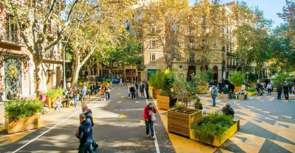 Barcelona superblock — streets reclaimed for people with planters, pedestrians, and cyclists