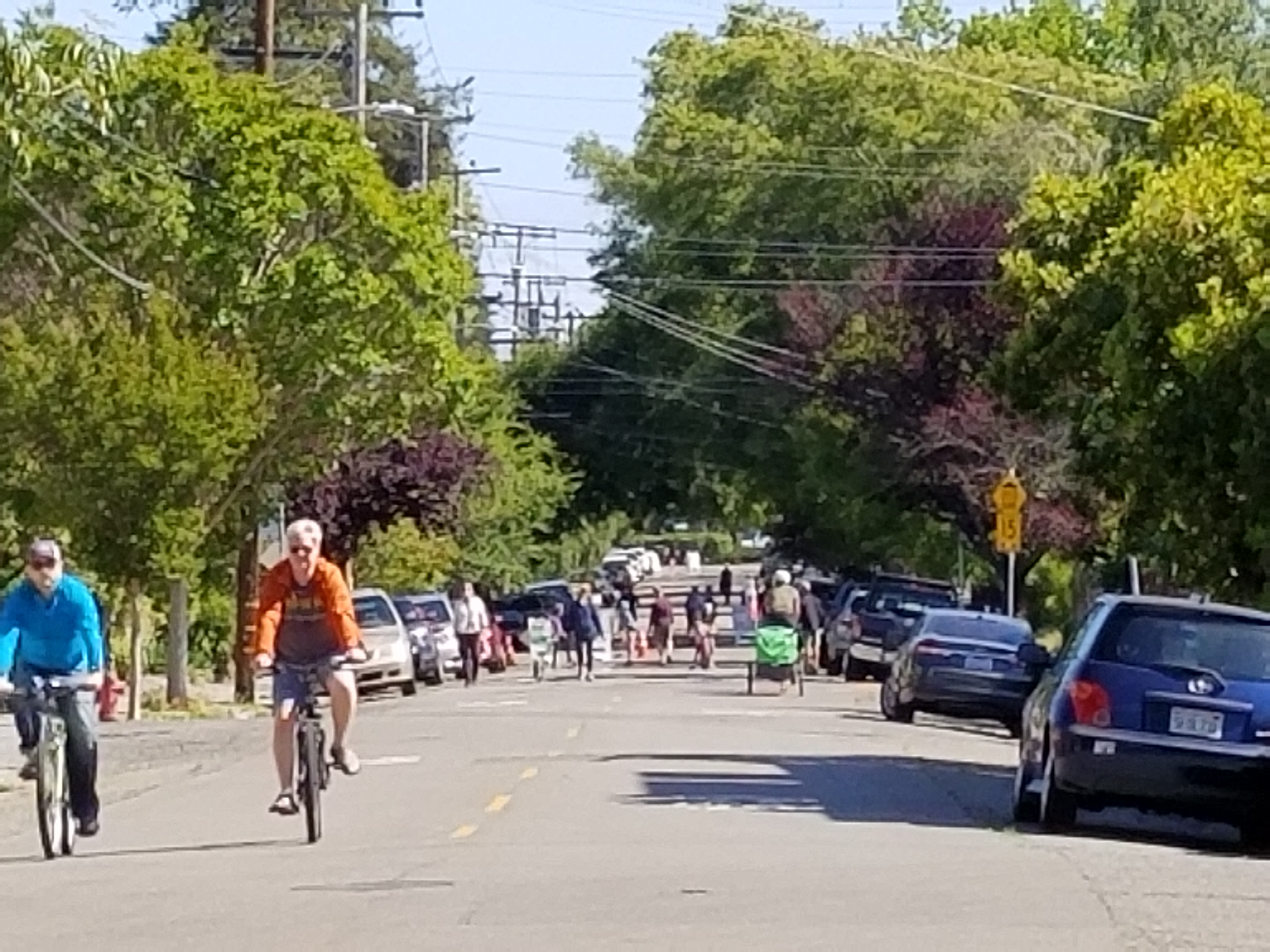 Cyclists and pedestrians on a slowed residential street — residents' safety